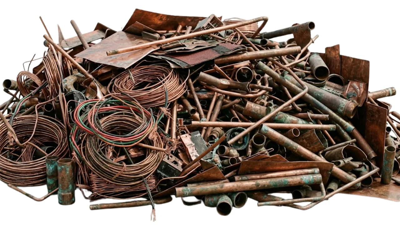 Mixed copper scrap pieces in recycling bin