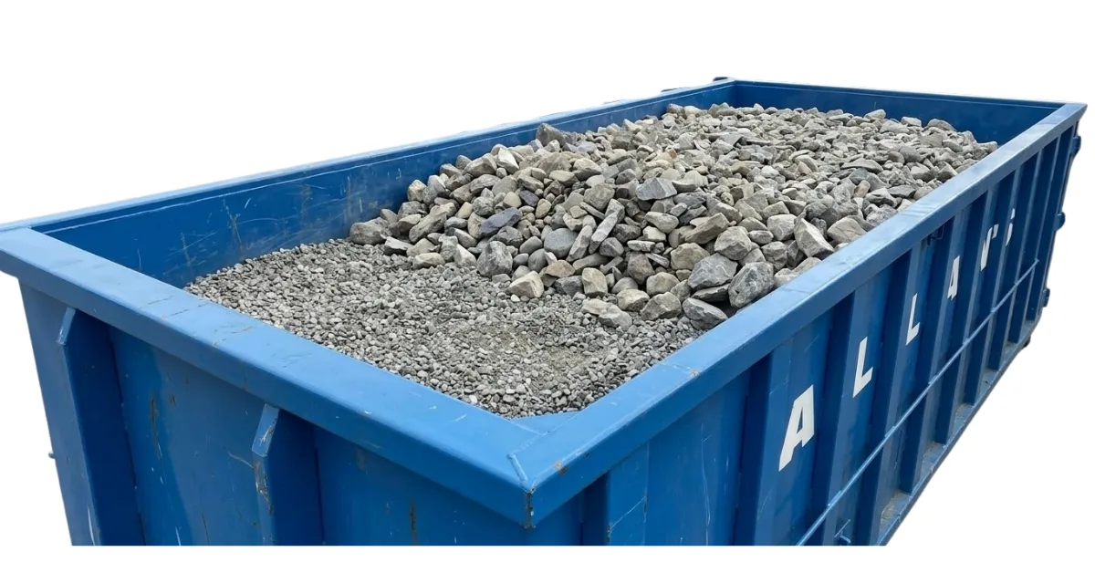 Rock and gravel loaded in a roll-off bin